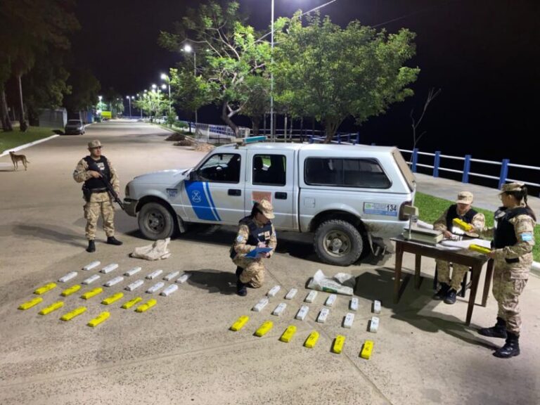 Efectivos de la Prefectura Naval revisan bolsas de arpillera con droga incautada en Itatí